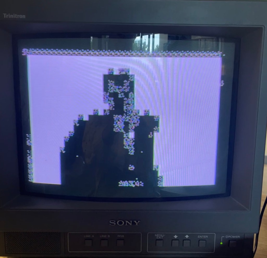 black pixelated screenshot of Rick Astley dancing across a white background on a black Sony CRT